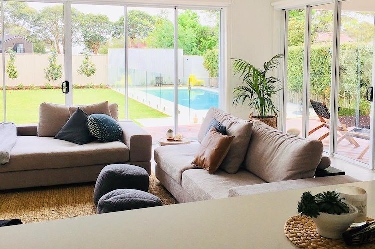 Living room and backyard with a pool 