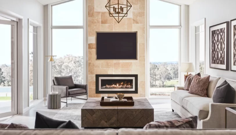 Acreage home sunlit living room stone fireplace clarendon homes